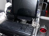 a computer sitting on a desk in the back of a bus