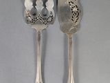 two spoons and a fork on a table