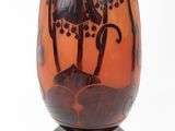 a brown vase with a black design on it