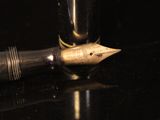 an image of a fountain pen and a glass on a table