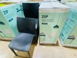 a black chair sitting next to a box of boxes on the floor