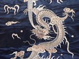 a dragon that is on a blue and gold cloth