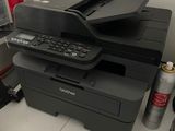 a printer sitting on top of a desk next to other office supplies