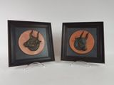 two framed pictures of a bull and a bull head on a white background
