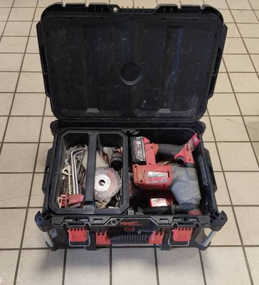 a tool case with tools inside of it on the floor