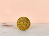 a gold coin sitting on top of a marble counter top