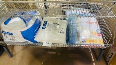 a shopping cart with a lot of bags of food inside of it