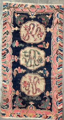 a blue and pink rug with two lions on it
