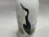 a white vase with a black and white bird painted on it