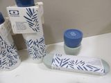 a bottle of water and a container of toothpaste on a counter