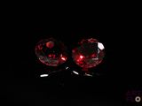 pair of red crystal stud earrings on a black background