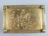 an antique gold plate with a picture of a man on a horse