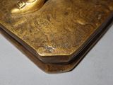 a gold statue of a person on a skateboard on a table