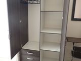 an image of a bedroom with a closet and a desk