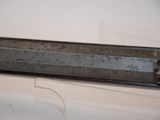 a close up of a metal object on a white surface
