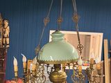 an image of a living room with a blue couch and a chandelier