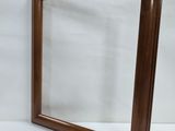 a wooden frame with a mirror on the side of it