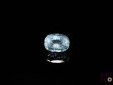 a close up of a blue diamond on a black surface