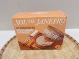 the box is open on a wicker basket with a bottle of body lotion