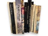 a lot of books that are stacked on top of each other