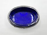 a blue bowl sitting on a table with a white background