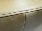 a close up view of a beige leather couch