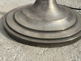 a close up of a metal object on a cement surface