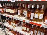bottles of wine on a shelf in a store for sale