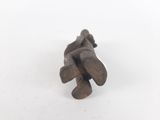 a close up of a small wooden object on a white surface
