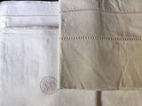 a close up of a pair of white towels on a bed