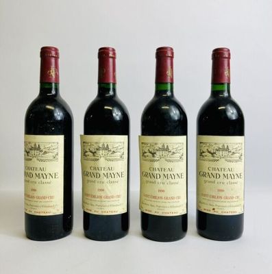 three bottles of red wine are lined up on a white surface