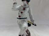 a figurine of a man with a knife in his hand