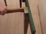 a man that is holding a piece of wood in his hand