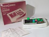 une manette de jeu posée à côté d'un livre sur une table