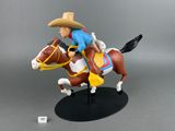 toy figurine of a cowboy on a horse with a hat on