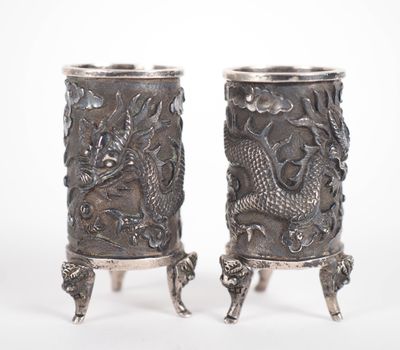 pair of antique silverware vases with dragon heads on stands