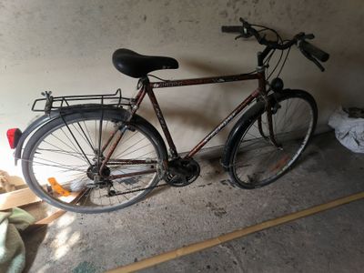 a bike that is leaning against a wall in a garage