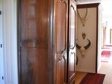 a large wooden cabinet in the middle of a hallway
