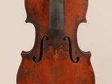 an old violin with a bow hanging from the back