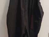 a black dress hanging on a hanger on the wall