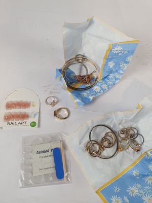 a bag of rings and other jewelry on a table