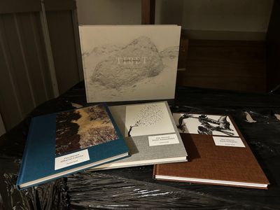 several books are sitting on a table in a room