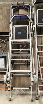 a ladder that is next to a wall with a computer on it