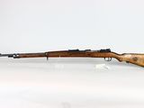 a rifle on a white surface with a white background