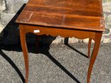 a small wooden table with a drawer on top of it