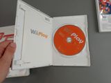 someone is holding a wii game in a white case