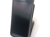 a cell phone that is sitting on top of a stand