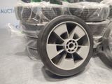 a pile of tires sitting on a table with plastic wrapped around them