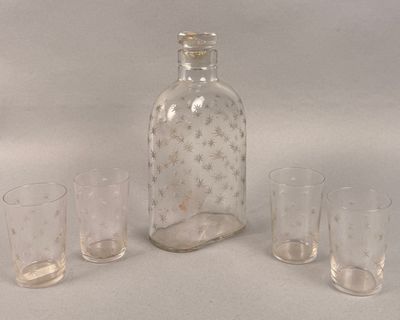 four glasses and a bottle sitting on a table