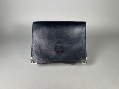 a black leather wallet sitting on top of a white table